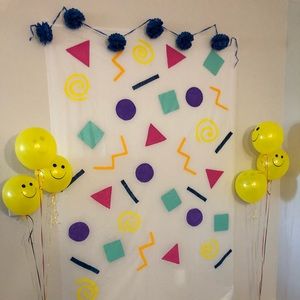 90s themed back drop with party supplies
